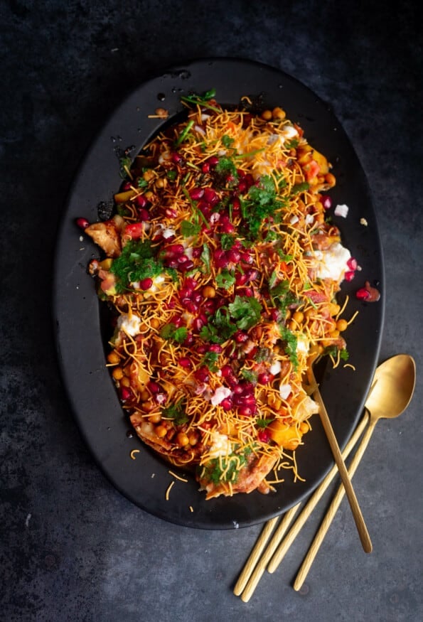 Samosa Chaat in a black oval plate