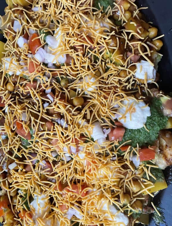 Sev and toppings added to chaat