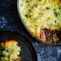 Indian Shepherd's Pie in a casserole dish with a portion in a plate at the side