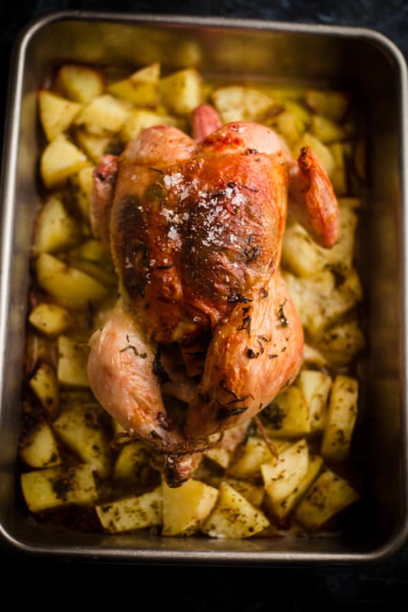 Greek Roast Chicken with potatoes in a tin