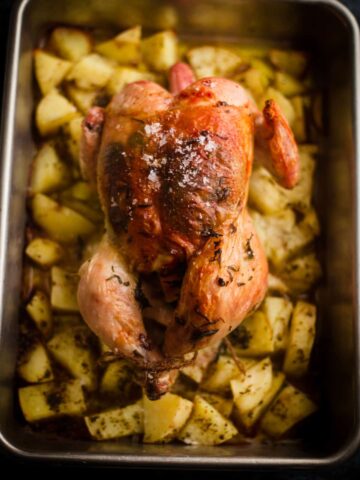 Greek Roast Chicken with potatoes in a tin
