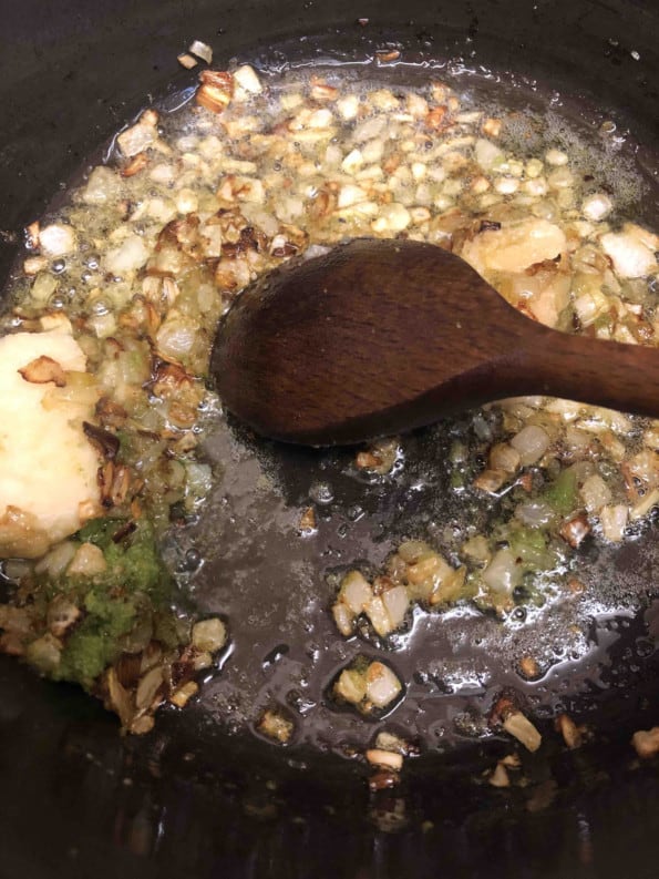 Golden brown onions with ginger, garlic and green chilli in pot
