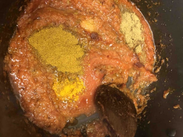 Garam masala and curry powder added to pot
