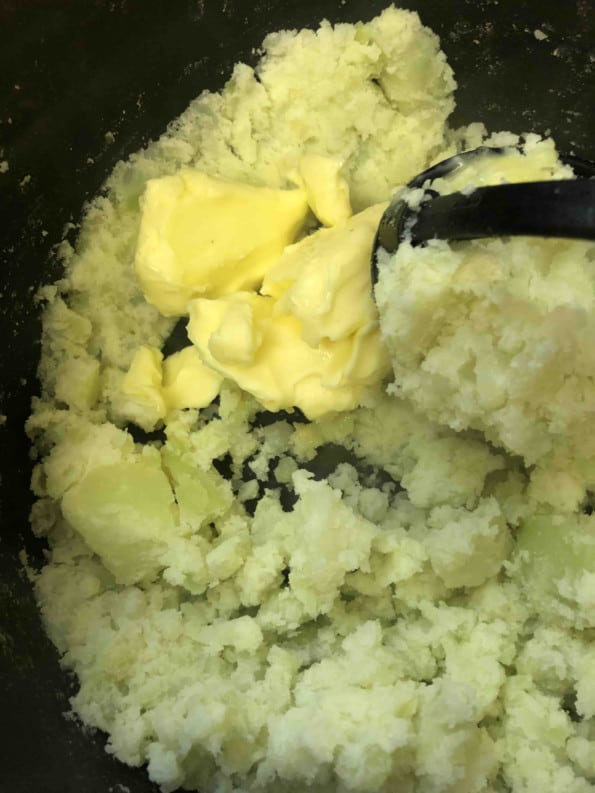 Butter and potatoes in a pot