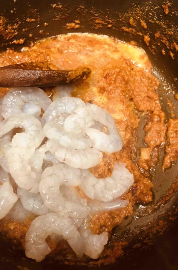 Prawns added to curry base in pot