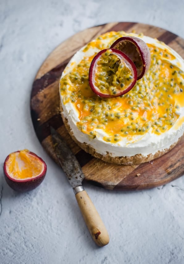 Passionfruit Cheesecake on a board with a knife to side