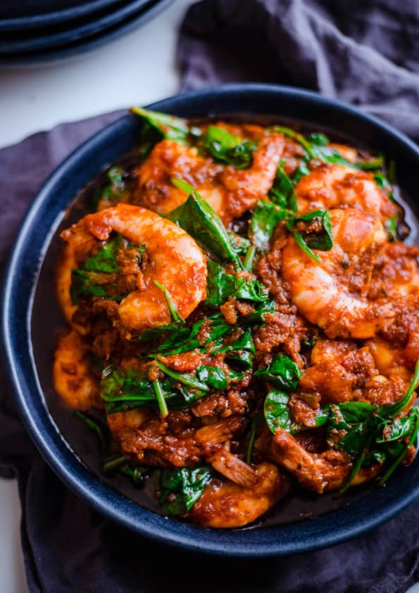Prawn and Spinach Curry in a blue bowl on a table