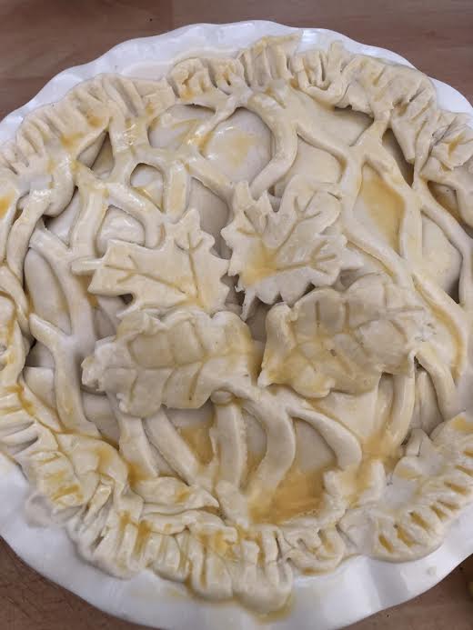 Puff pastry with leaf design on top of pie