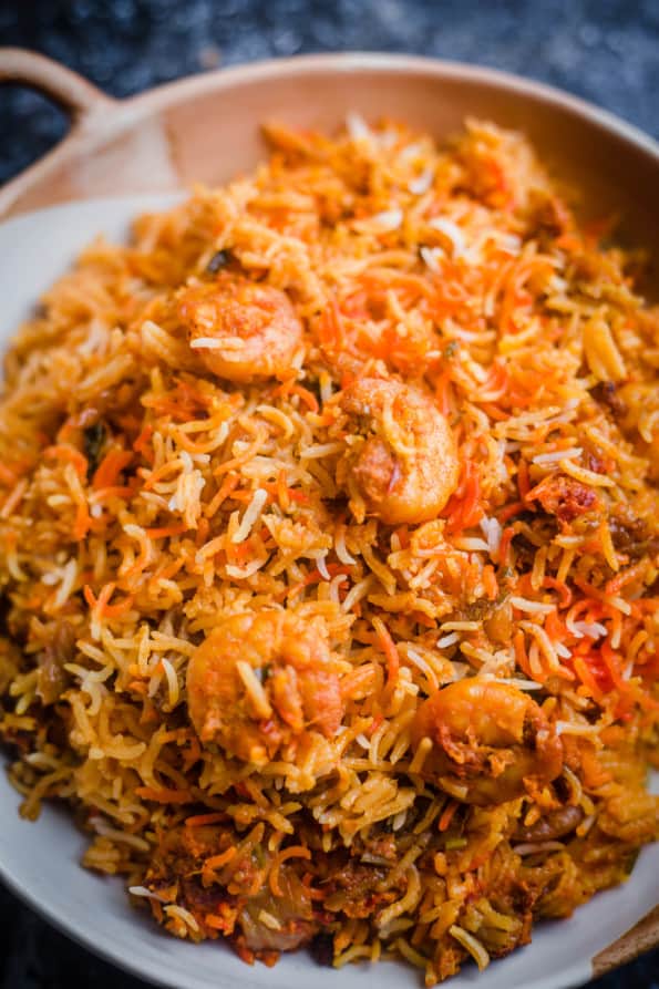 Prawn Biryani in a white and terracotta dish with handles on a table