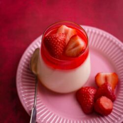 Mahalabia in a cup with strawberries on top