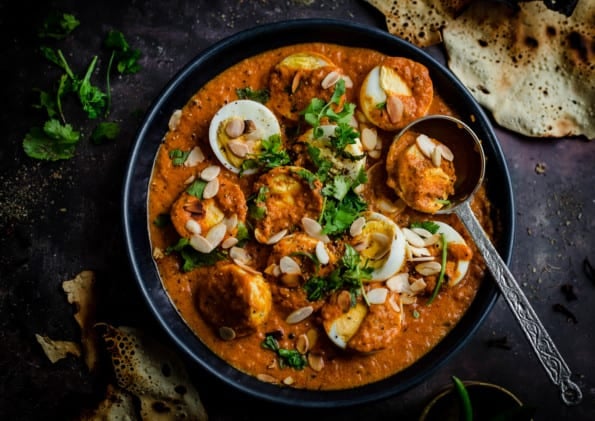 Egg Mughlai with coriander on top in blue bowl