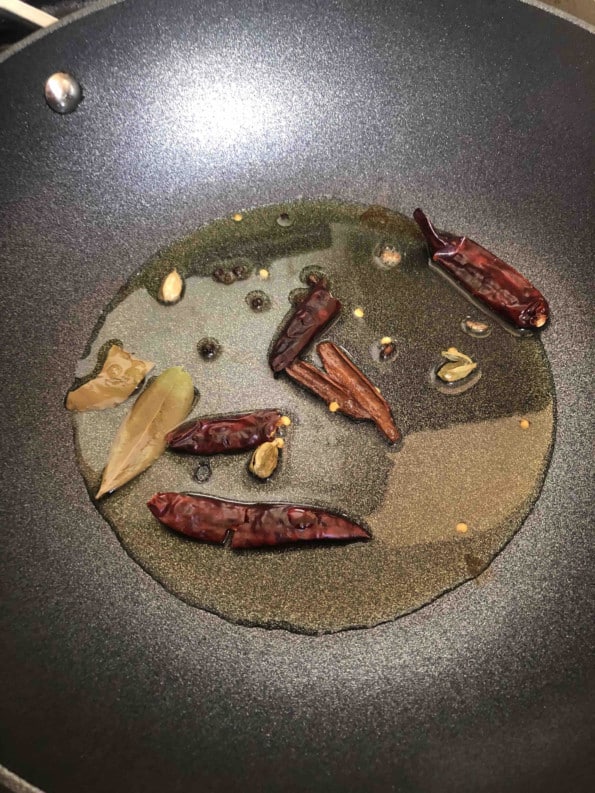Spices added to oil in wok