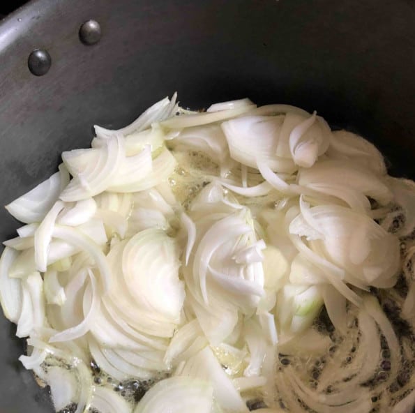 Onions cooking in oil/ghee in pot
