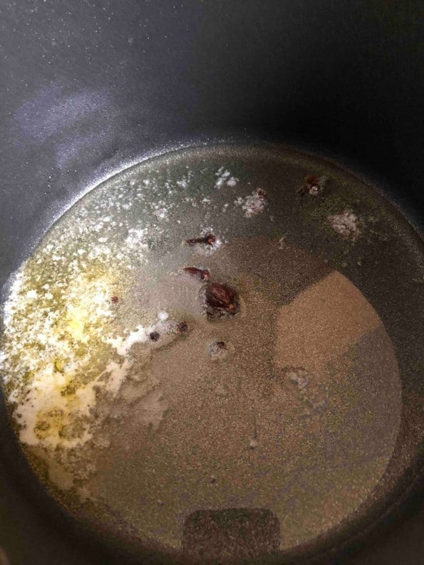 Ghee, oil and whole spices in pot