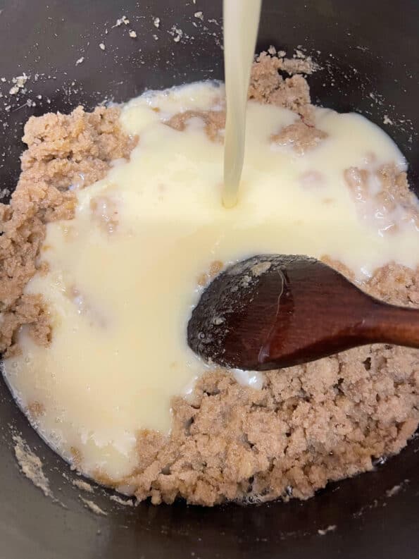 Milk being added to Soji in pot