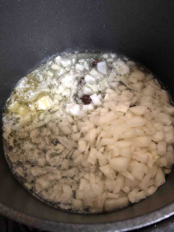 Onions in pot with oil, spices and ghee