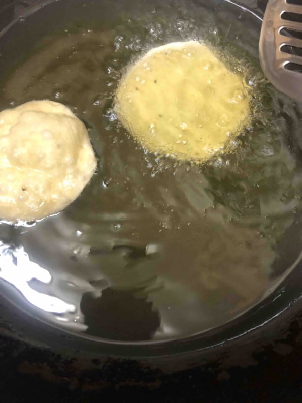 Papdi frying in oil in deep frying pan