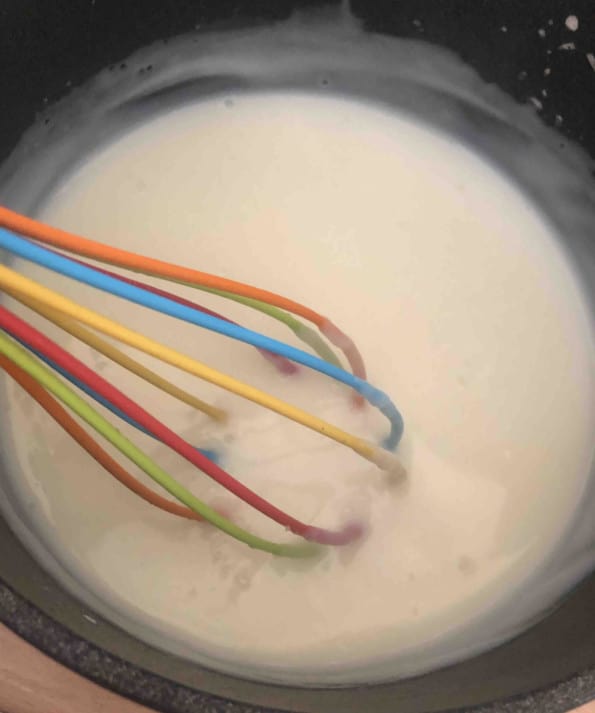 Milk and cornflour mix being whisked in pot