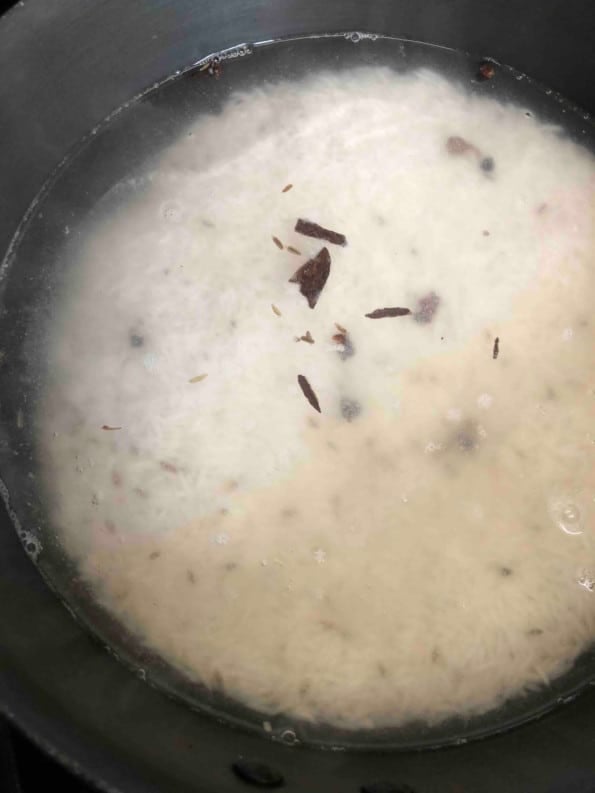 Rice with whole spices in pot