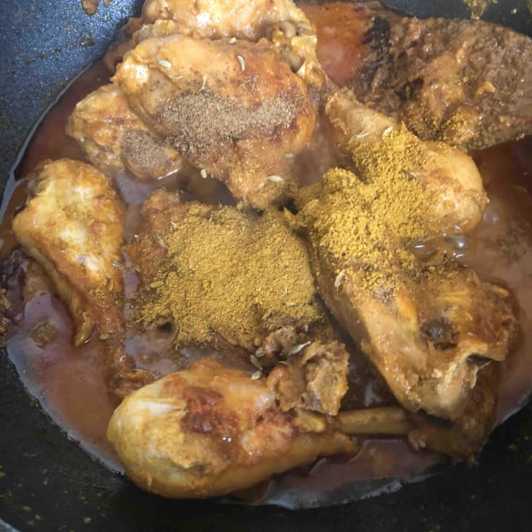 Spices added on top of Chickening wok