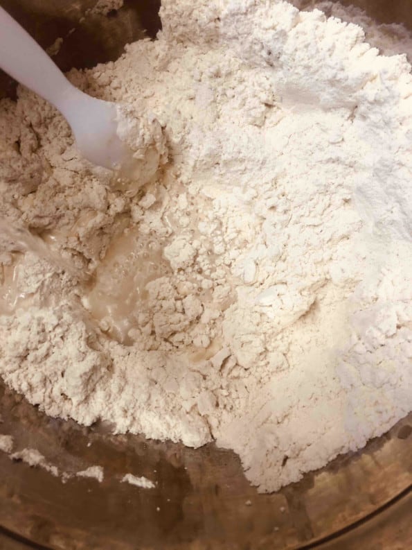 Dry ingredients in bowl being mixed with a spoon