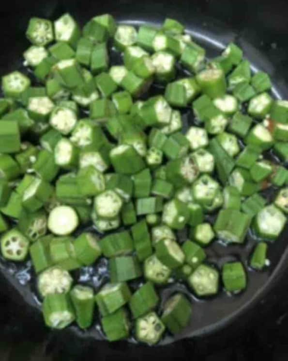 Okra added to oil in pot