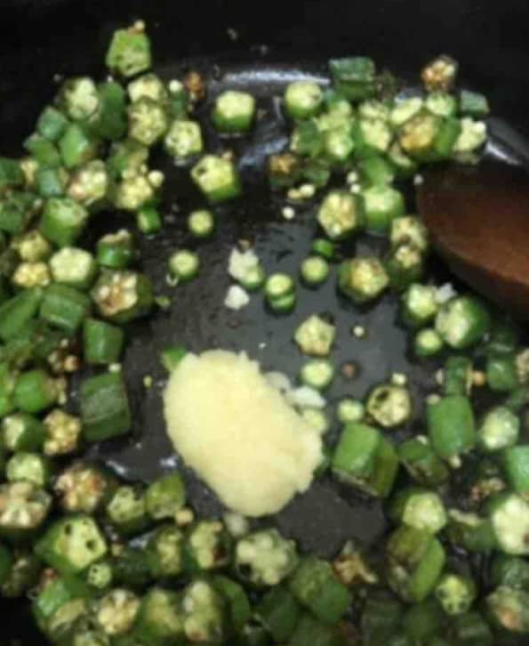 Garlic added to pot with okra