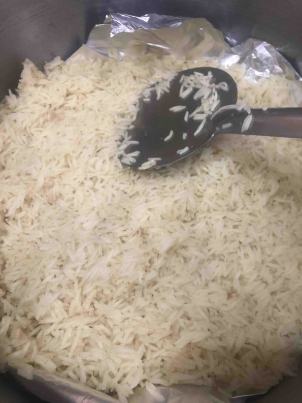 Rice being added to bottom layer of pot