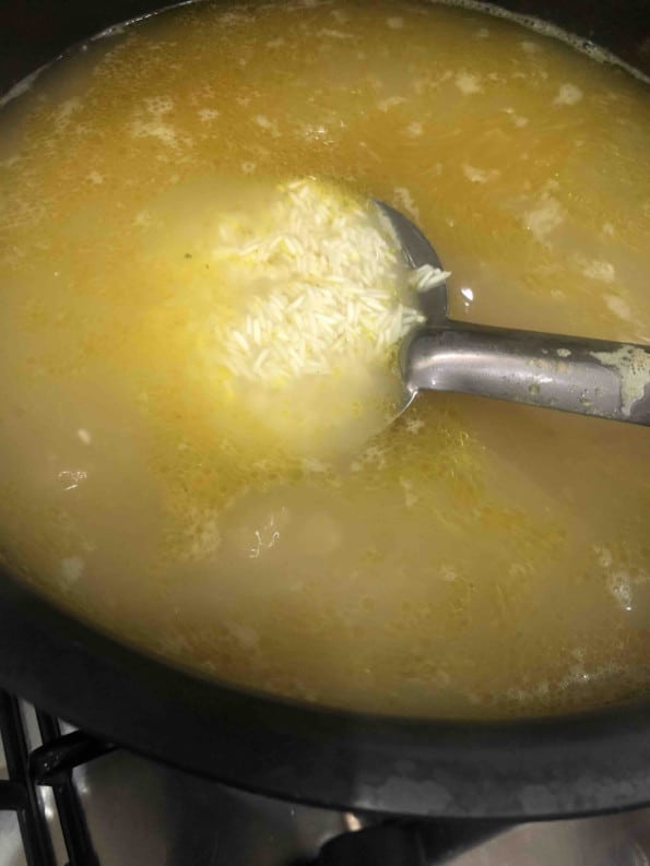 Rice being parboiled in a large pot