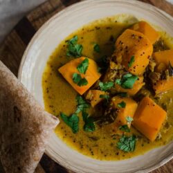 Pumpkin Curry in a plate with chappati to the side