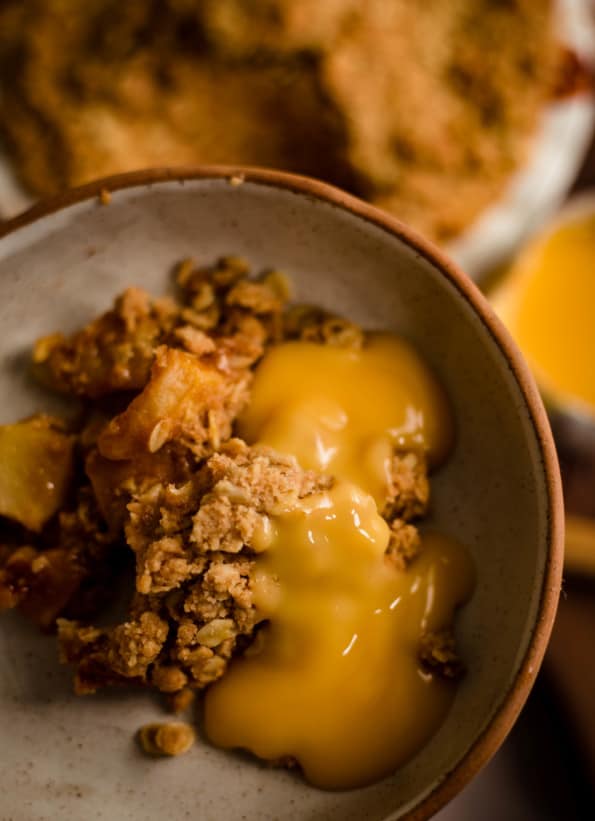 Apple Crumble in a bowl with custard