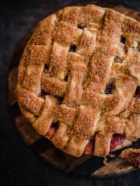 Apple and Blackberry Pie on a wooden chopping board