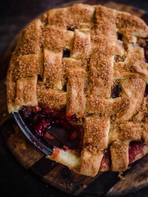 Apple and Blackberry Pie with a piece cut out showing interior