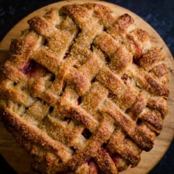 Apple and Blackberry Pie on round wood board