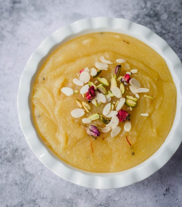 Soji Halwa in a bowl topped with flaked almonds