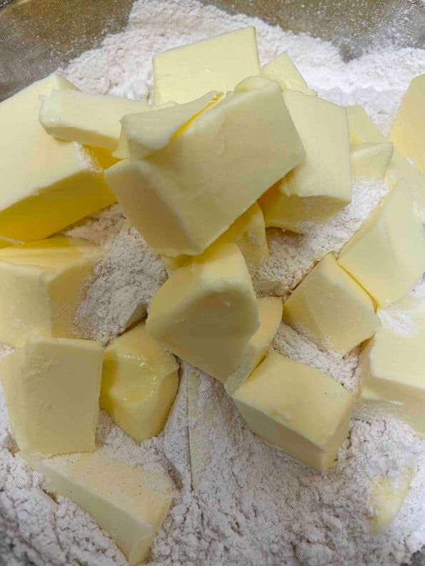 Cubed cold butter in flour in a bowl