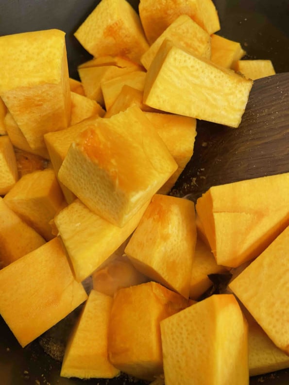Pumpkin cut into cubes on board