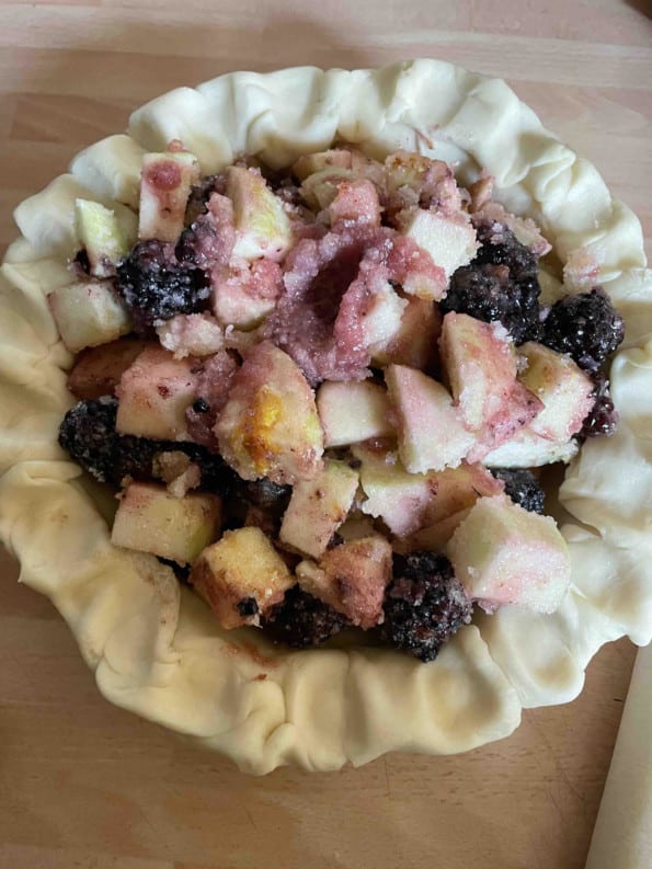 Fruit filling added to pie dish
