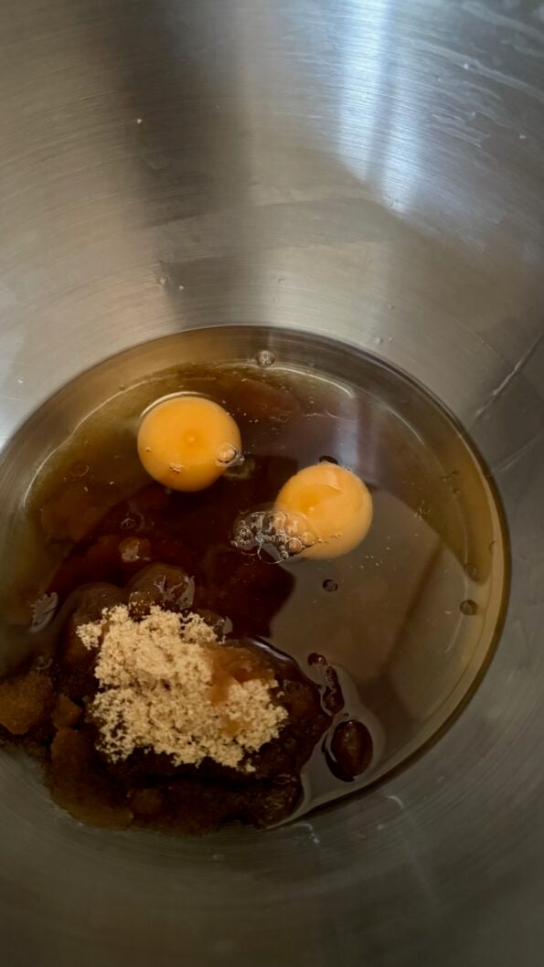 One tin Chai Spiced Carrot and Walnut Cake Eggs, Oil and Sugar in bowl