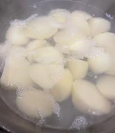 Potatoes in boiling water in pot