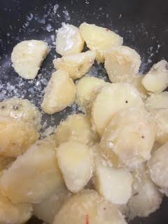 Potatoes with rough edges in pot
