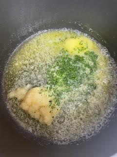 Garlic, Butter and Parsley being combined in pan