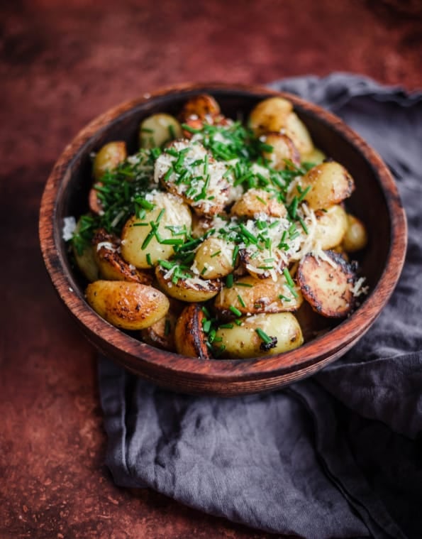 Garlic Parmesan Potatoes in a bowl with chives on top