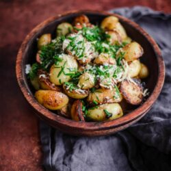Garlic Parmesan Potatoes in a bowl with chives on top