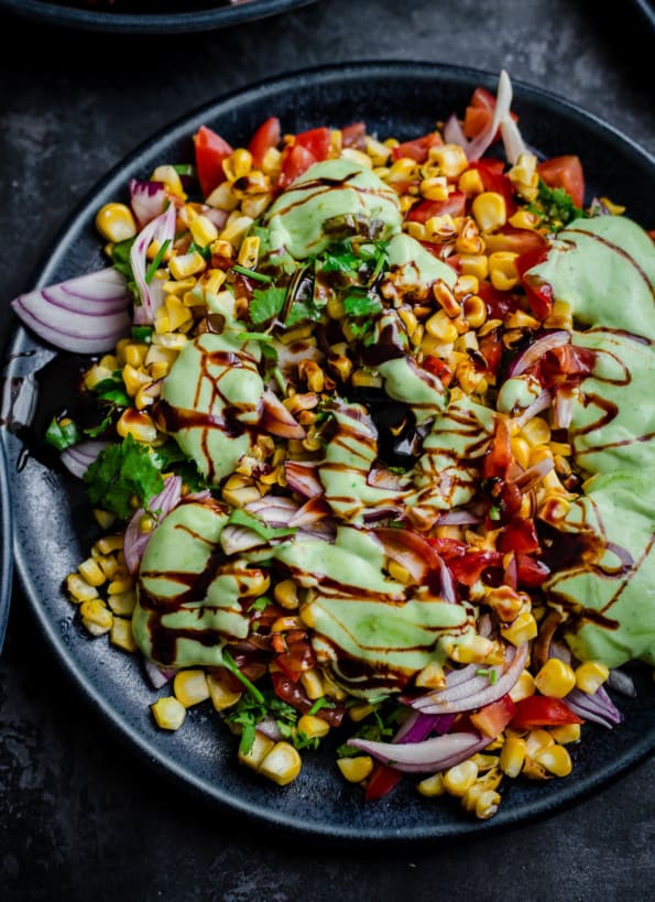 Corn Chaat in a plate with Vegetables and Sauces