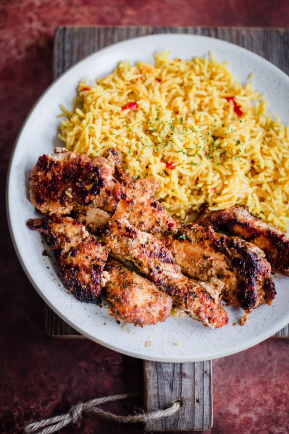Chicken Tenderloin with turmeric rice in a plate