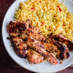 Chicken Tenderloin with turmeric rice in a plate