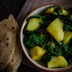 Aloo Palak in a small bowl with Chapatti to side
