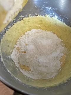 Flour and Baking Powder added to batter in bowl