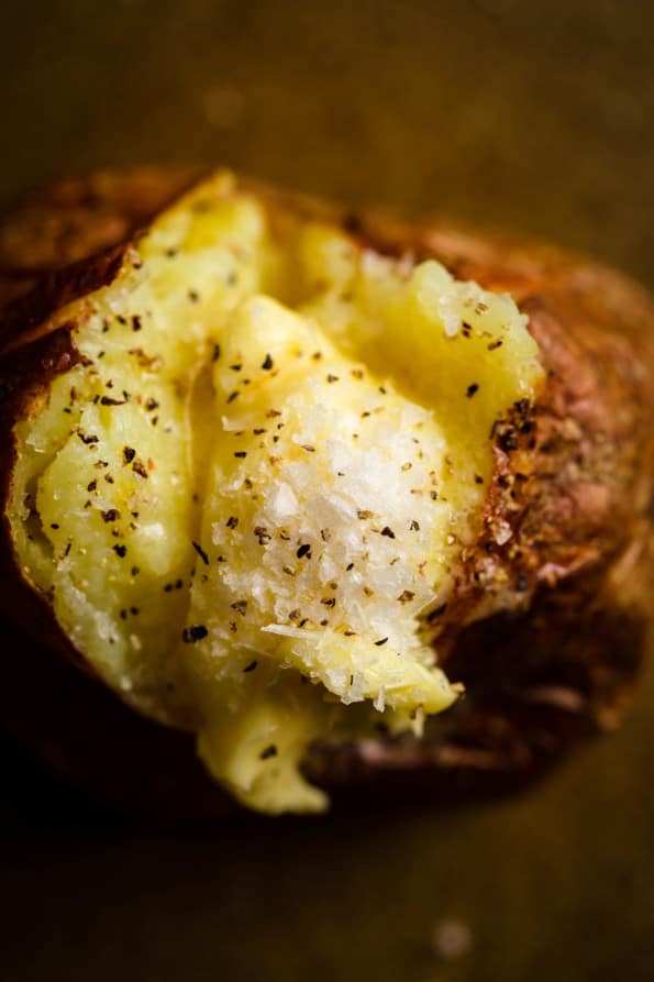 Ninja Foodi Baked Potato with Butter and seasoning on a plate